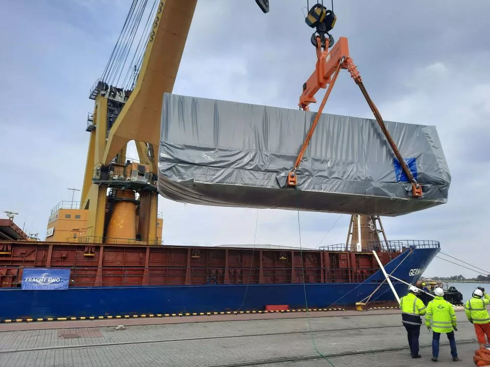 Crane lifting freight onto a vessel