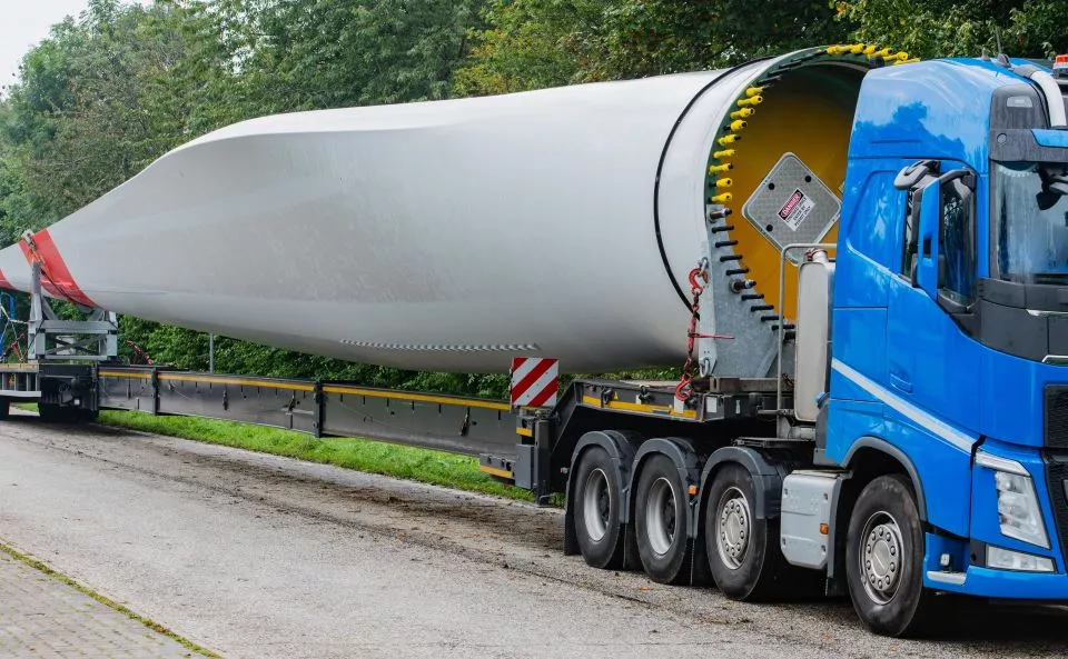 Large truck transporting rotor blades