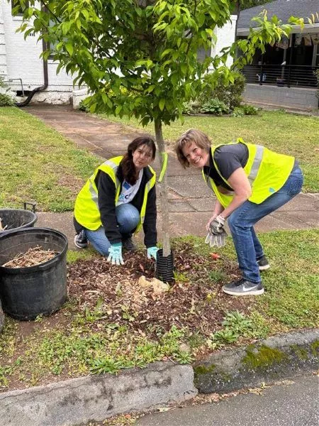 Two Fracht employees planting a tree