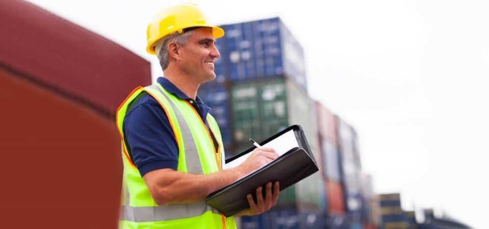 Man in hard hat taking notes