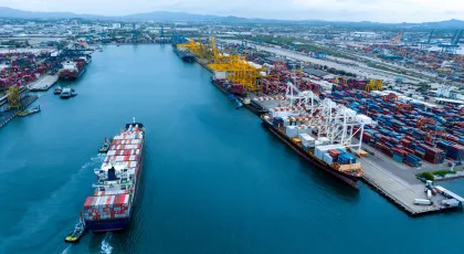 Freight vessel in water by port