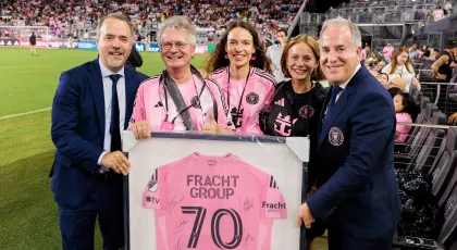 Fracht employees holding jersey