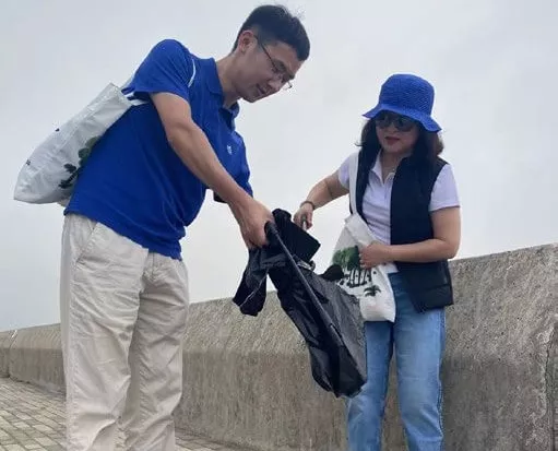 Fracht employees cleaning up outside