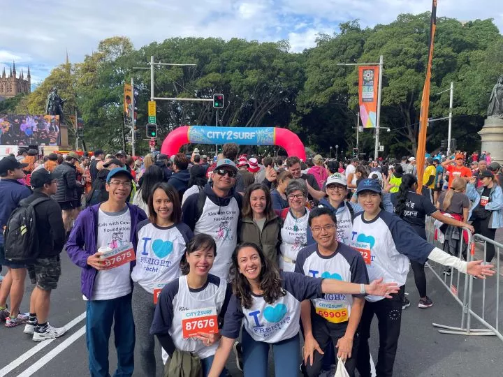 Fracht employees posing at finish line of race