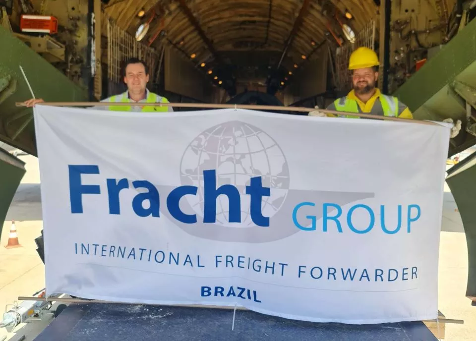 Fracht employees holding sign