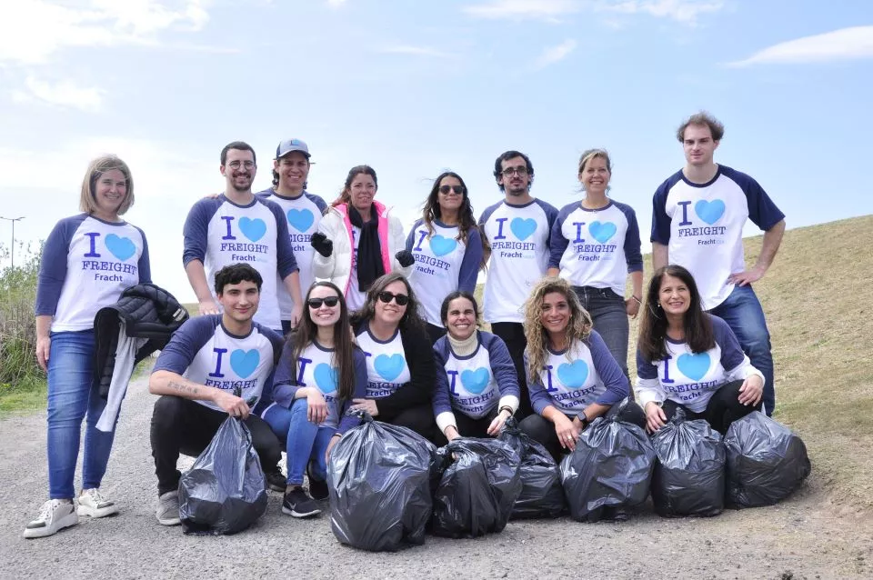 Fracht employees cleaning up a park