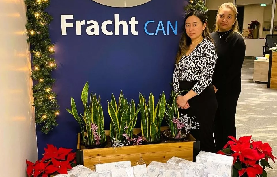 Fracht employees with wrapped gifts