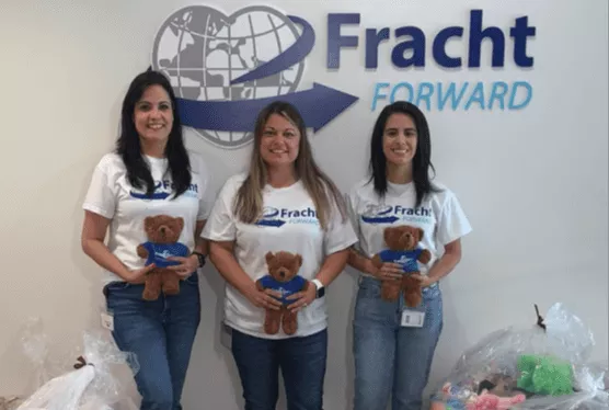Fracht employees holding stuffed animals