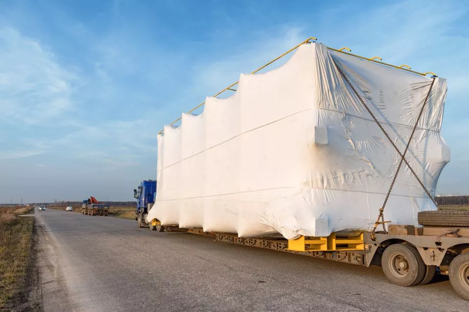 Large freight being moved on flat truck