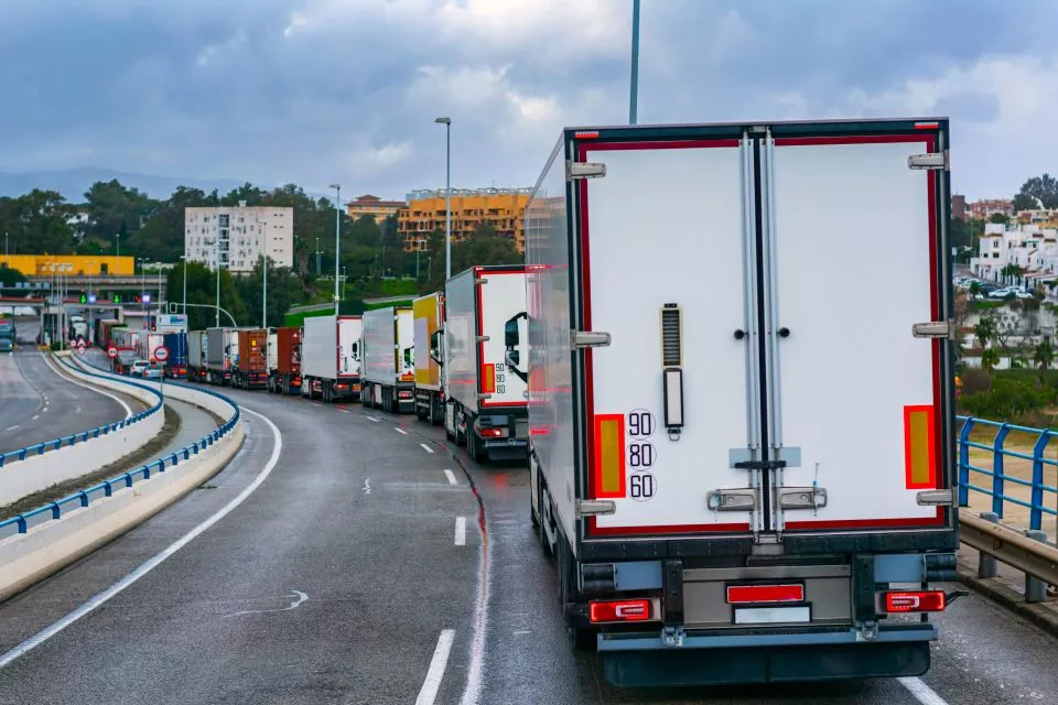 Freight trucks in line on road
