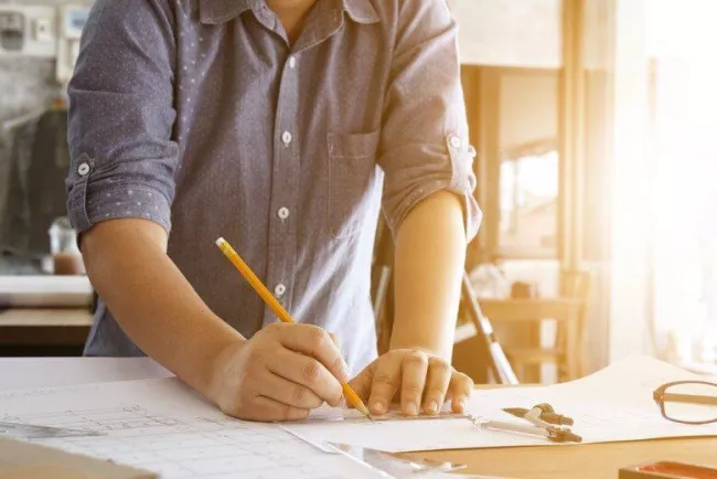 Person at a desk with a pencil