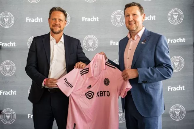 Two men holding soccer jersey