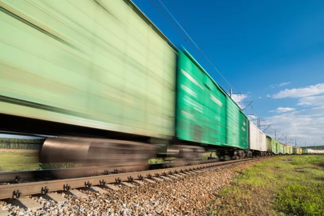 Blurry green freight train in motion